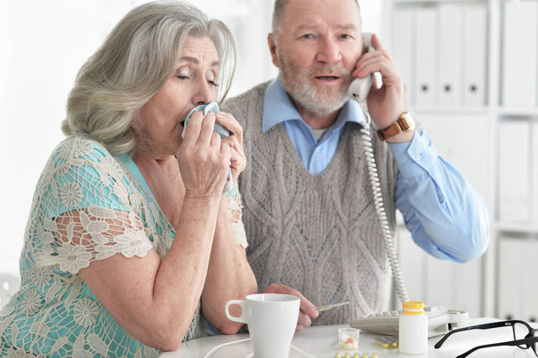 ill Senior couple  at home calling doctor - Foto, Bild