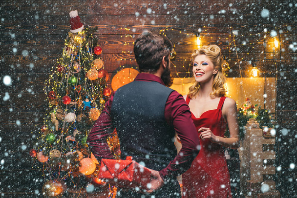 Woman in snow. Excited and happy Christmas or New Year emotions. Shopping couple holding gift boxes. Funny couple with colorful make-up and retro hairstyle for Christmas or New Year party. - Фото, зображення