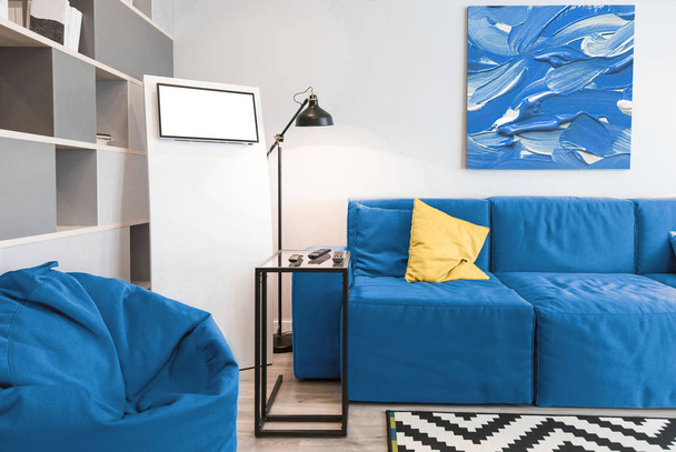 Interior of the room in light colors. Classic blue color 2020 sofa - Photo, Image