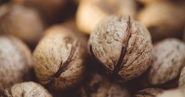 A lot of walnuts in the peel closeup. - Valokuva, kuva