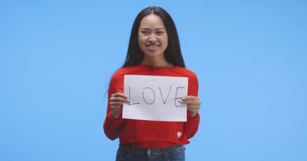 Woman holding up love sign - Footage, Video