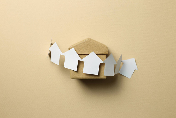 Paper house model on brown background. Real estate concept - Photo, image