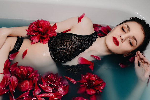 girl in lingerie enjoys in bath with flower petals - Φωτογραφία, εικόνα