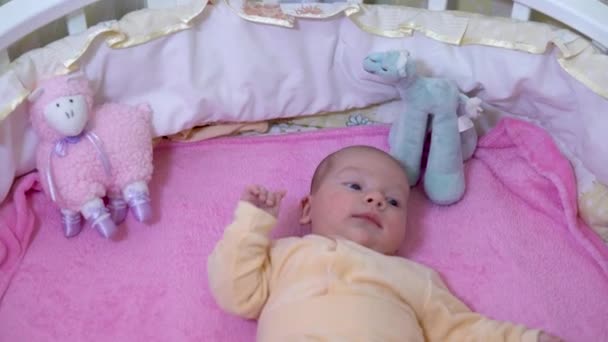 The baby is in the crib. The child tossing and turning. The camera zooms in - Video