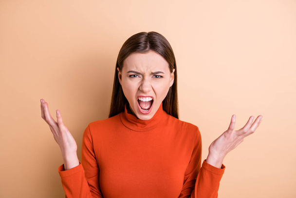 Close-up portrait of her she nice attractive sullen gloomy frustrated outraged desperate straight-haired girl expressing rage resentment isolated over beige pastel color background - Fotografie, Obrázek