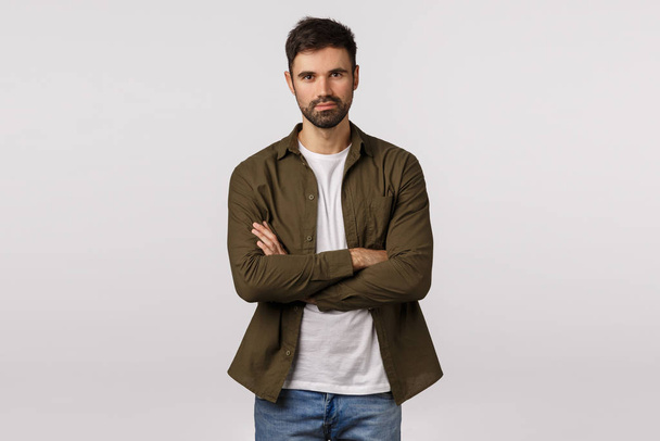 Professional, recruitment and motivation concept. Daring and confident good-looking bearded guy standing assertive, hands crossed over chest, ready take action, look determind, white background - Photo, Image