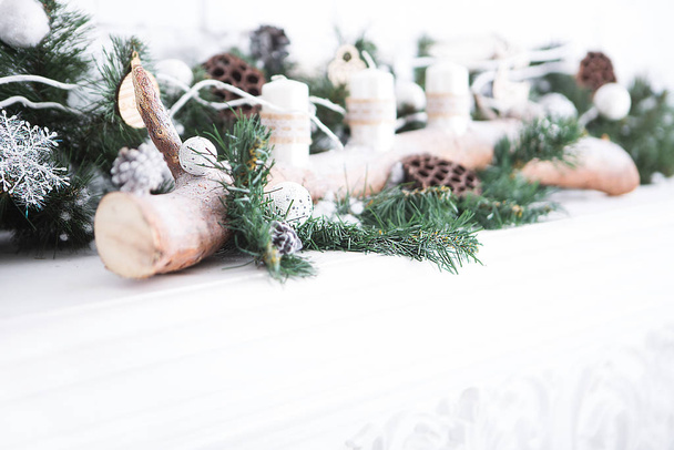 Рождественский фон с декором полки, украшенной свечами, ветками елки, бревен и рождественских игрушек
 - Фото, изображение