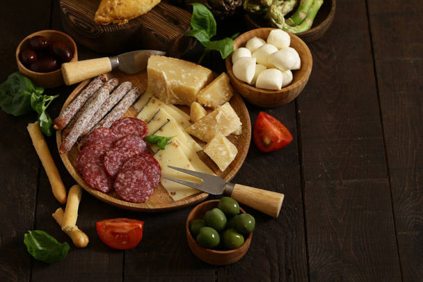 delicious snacks and antipasti on a wooden table - Photo, Image