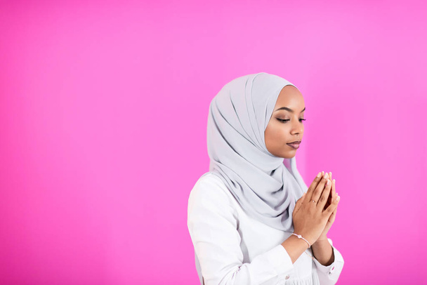 African Muslim woman makes traditional prayer to God - Фото, изображение