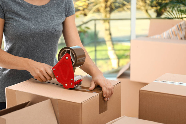 Woman packing box indoors, closeup. Moving day - Φωτογραφία, εικόνα