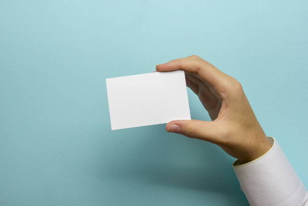 Hand holding business card blank on abstract background - 写真・画像