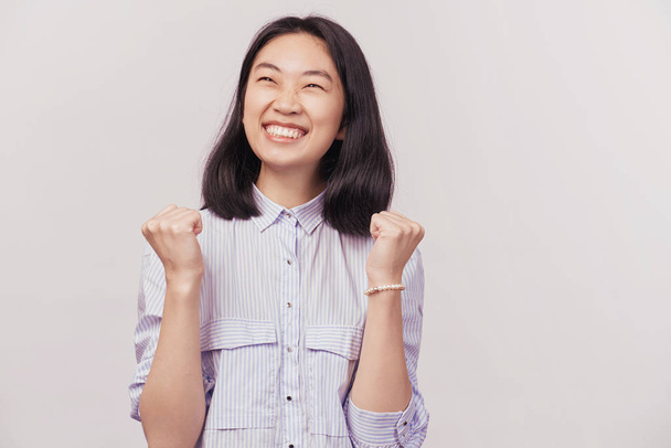 Girl excited for success with arms raised - Photo, image