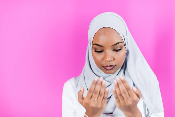African Muslim woman makes traditional prayer to God - 写真・画像