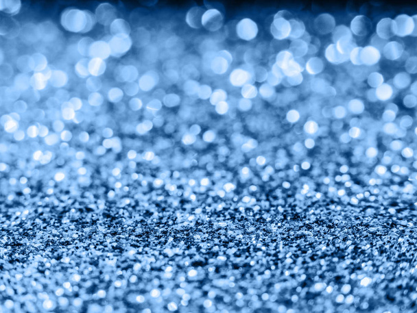 Blue sequin background. Blue sparkle background. Holiday abstract glitter background with blinking lights. Fabric sequins in bright colors. Fashion fabric glitter, sequins.  - Photo, Image