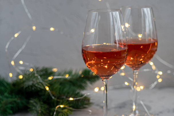 Orange wine is poured into two glasses. Celebratory drink. Family celebration. - Zdjęcie, obraz
