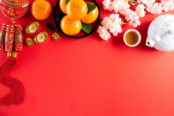 Chinese new year festival decorations pow or red packet, orange and gold ingots or golden lump on a red background. Chinese characters FU in the article refer to fortune good luck, wealth, money flow. - Photo, Image