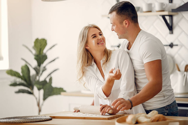 Beautiful couple prepare food in a kitchen - 写真・画像