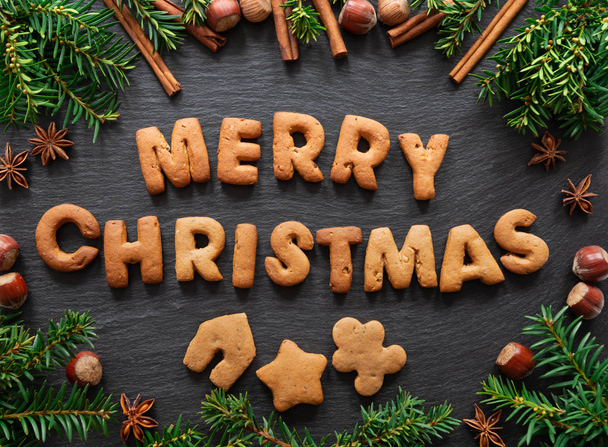 Gingerbread words Merry Christmas on dark stone background - Fotoğraf, Görsel