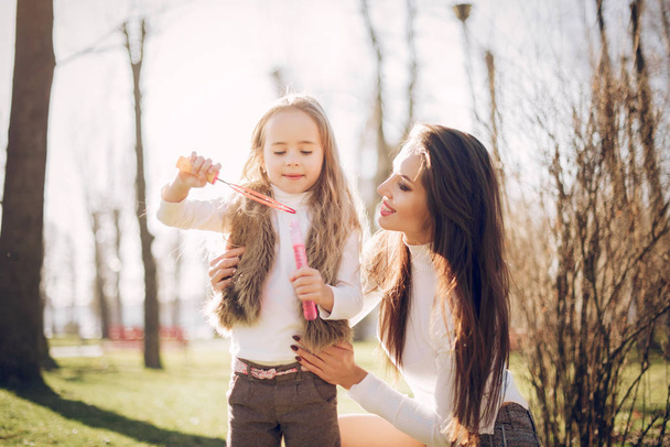 Cute and stylish family in a spring park - Foto, Imagem