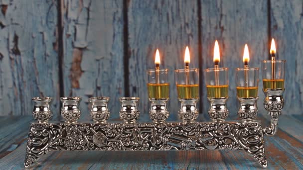 Czwarty dzień żydowskiego święta pięć świec Chanuka płoną na świetle menory - Materiał filmowy, wideo