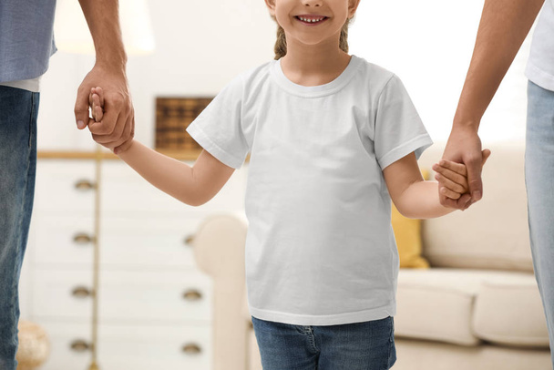 Happy family holding hands indoors, closeup view - Photo, image