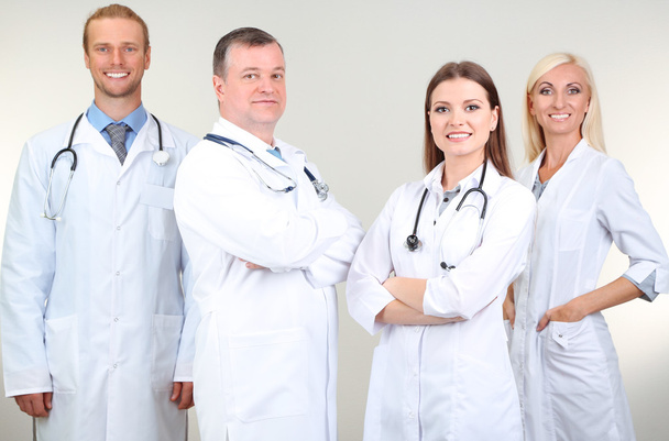 Medical workers on grey background - Foto, imagen