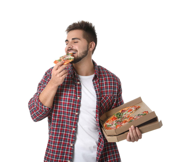Handsome man eating pizza isolated on white - Фото, изображение