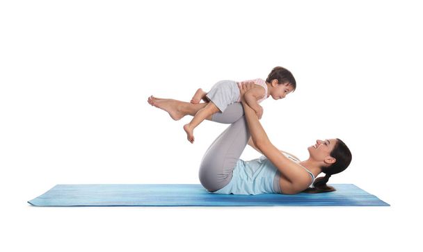 Young woman doing exercise with her son isolated on white. Time for fitness - Фото, зображення