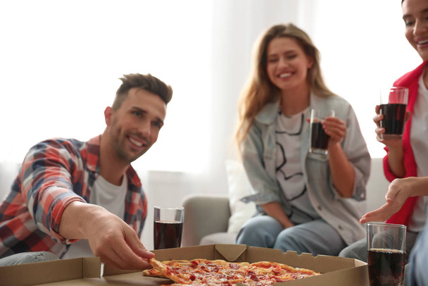 Group of friends eating tasty pizza at home - Foto, Imagem