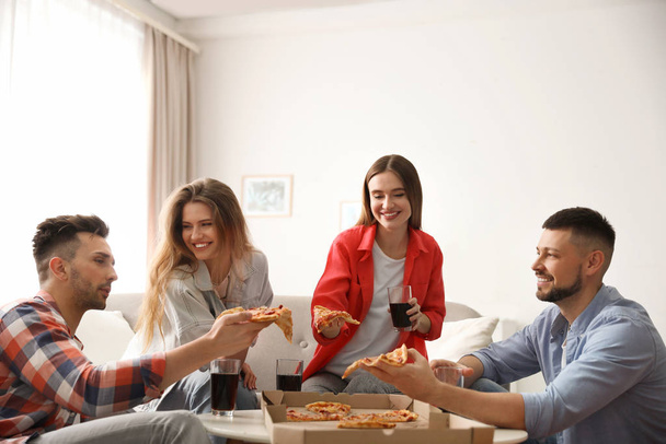 Group of friends eating tasty pizza at home - Fotografie, Obrázek