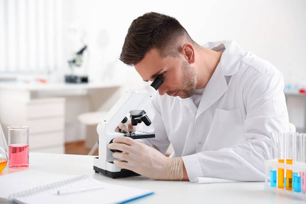 Scientist using modern microscope at table. Medical research - Fotó, kép
