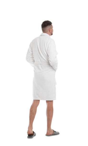 Man wearing bathrobe and slippers on white background - Foto, Imagen