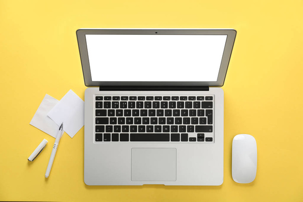 Laptop and office stationery on yellow background, flat lay - Photo, Image