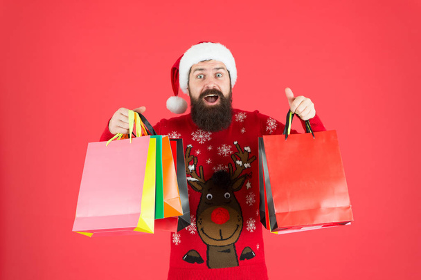 Delivering your purchase. Shopping with pleasure. Man bearded hipster wear winter sweater hold shopping bags. Buy new year gifts. Shopping for presents. Nice purchase. Discount for club members - Photo, image