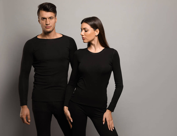 Couple wearing thermal underwear on grey background. Space for text - Foto, immagini