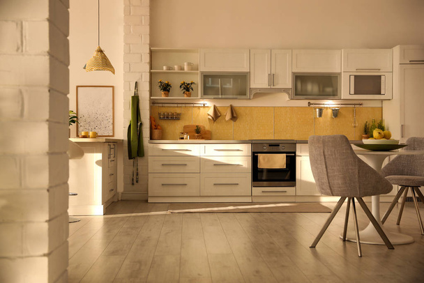 Modern kitchen interior with stylish white furniture - Fotó, kép