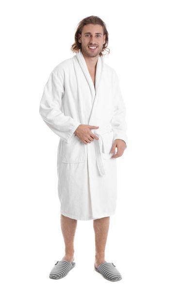 Young man in bathrobe on white background - Foto, Imagen