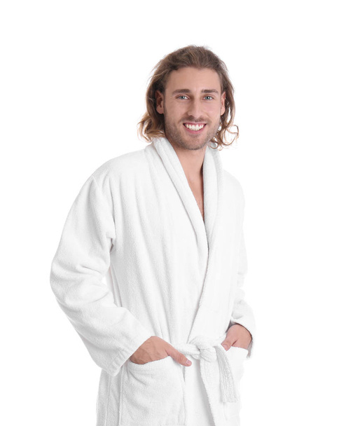 Young man in bathrobe on white background - Zdjęcie, obraz