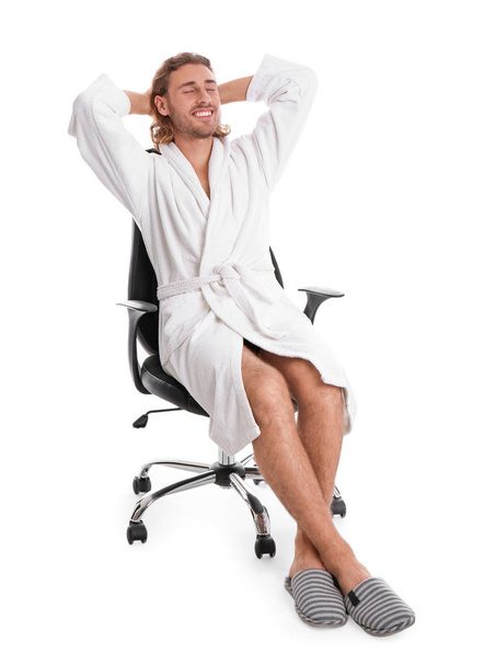 Young man in bathrobe on white background - Photo, Image