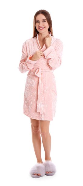 Young woman in bathrobe on white background - Foto, imagen