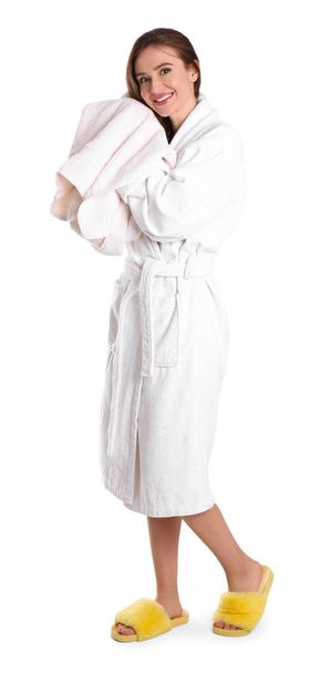 Young woman in bathrobe drying hair with towel on white backgrou - Photo, image