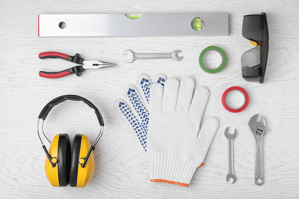 Flat lay composition with construction tools on white wooden bac - Fotoğraf, Görsel
