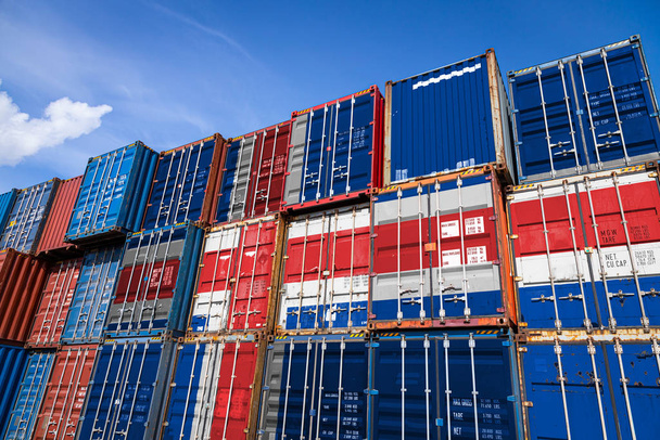 The national flag of Iceland on a large number of metal containers for storing goods stacked in rows on top of each other. Conception of storage of goods by importers, exporters - Photo, Image