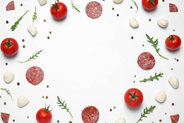 Composition with fresh ingredients and space for text on white background, top view. Pepperoni pizza recipe - Zdjęcie, obraz