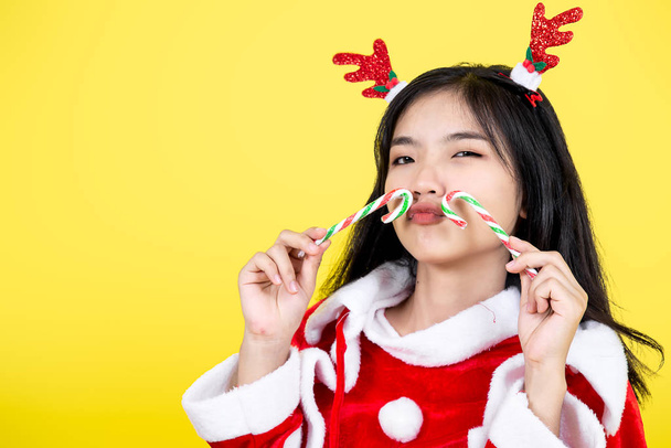 Asian teenager girl wearing Santa Claus costume holding Christma - Zdjęcie, obraz