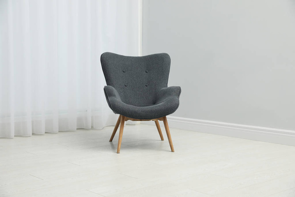 Comfortable armchair near window indoors. Stylish interior eleme - 写真・画像