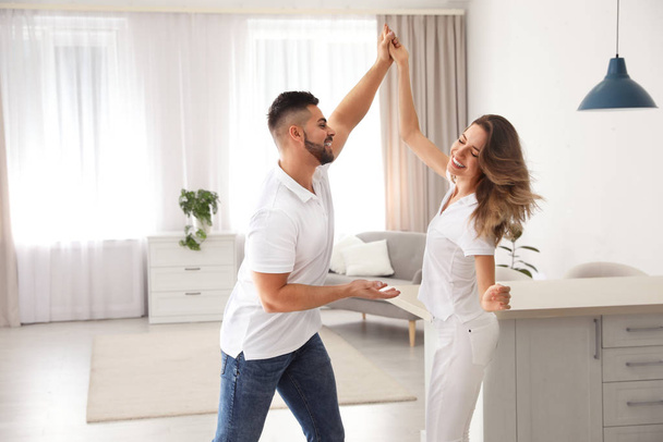 Lovely young couple dancing together at home - Photo, image
