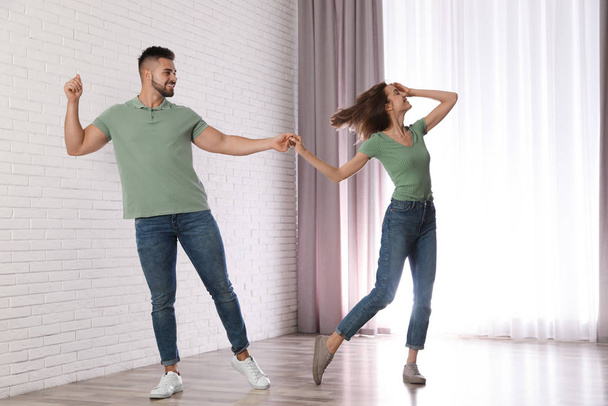 Lovely young couple dancing together at home - Φωτογραφία, εικόνα