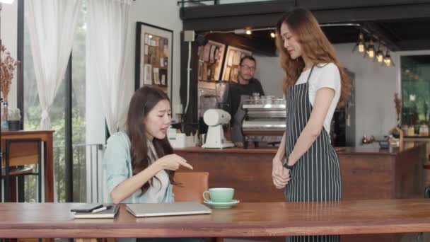 若いアジアのフリーランスの女性のクライアントは、千年のウェイトレスとの紛争を話すカフェ悪いサービスに不満を感じる、怒って失望した顧客はスタッフと話す間違った注文コーヒーショップについて不平を言う. - 映像、動画