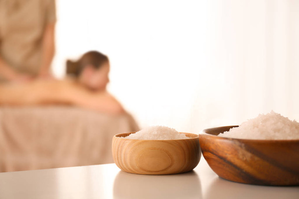 Bowls with sea salt on white table in spa salon - Foto, immagini
